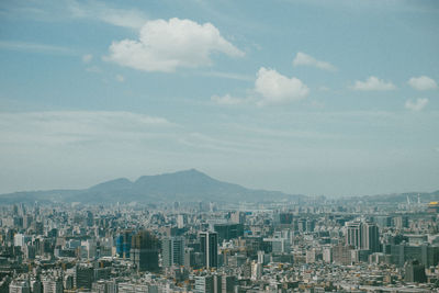 High angle view of buildings in city against sky