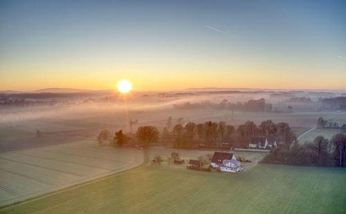 Scenic view of field against sky during sunset