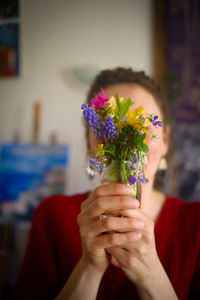 Midsection of woman holding flower