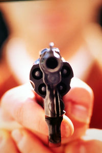 Close-up of person holding a gun
