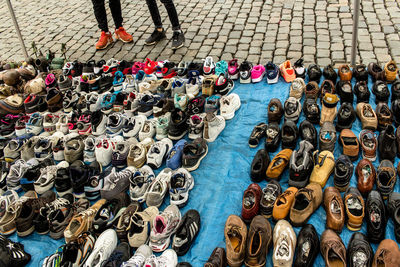 High angle view of various shoes for sale at market stall