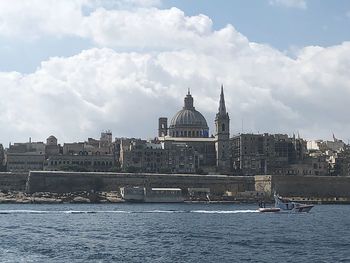 View of buildings against cloudy sky