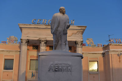 Low angle view of statue against clear blue sky