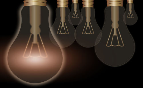 Digital composite image of illuminated light bulb