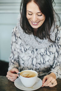 Young woman with cup of coffee