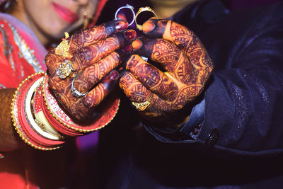 Young indian married couple showing off their rings to the camera