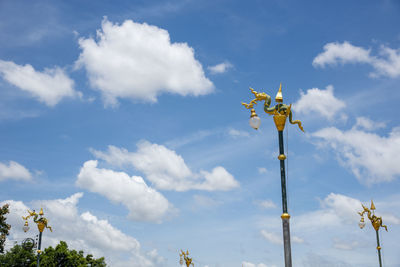 Low angle view of yellow umbrella against sky