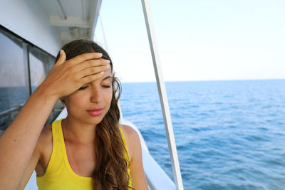 Close-up of young woman on boat in sea