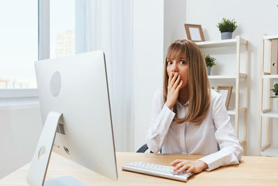 Businesswoman using laptop at office