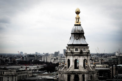 Buildings against cloudy sky