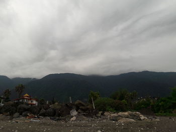 Scenic view of mountains against cloudy sky