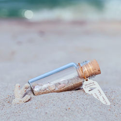 Close up of bottle on sand
