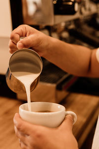 Midsection of woman holding coffee