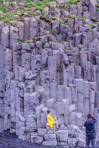 Rear view of man standing on rock