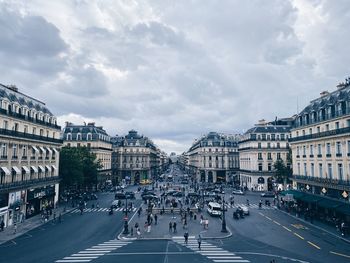 View of paris city street against cloudy sky with pedestrians and perspective 
