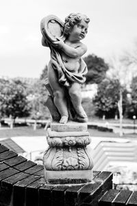 Buddha statue in park against sky