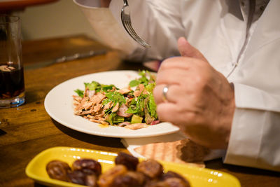 Close-up of man preparing food in restaurant