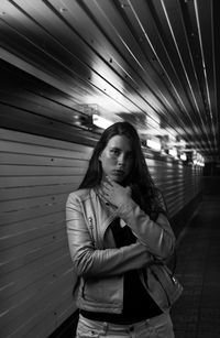 Portrait of young woman standing at night