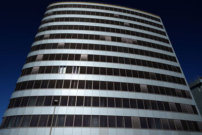 Low angle view of modern building against blue sky