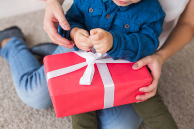 Midsection of man holding paper in box