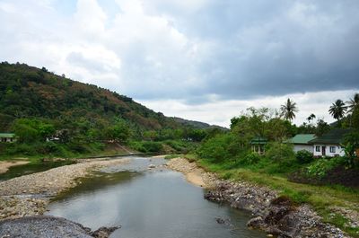 River amidst trees against sky