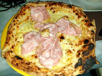 High angle view of pizza served on table