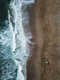 High angle view of beach with surf board 