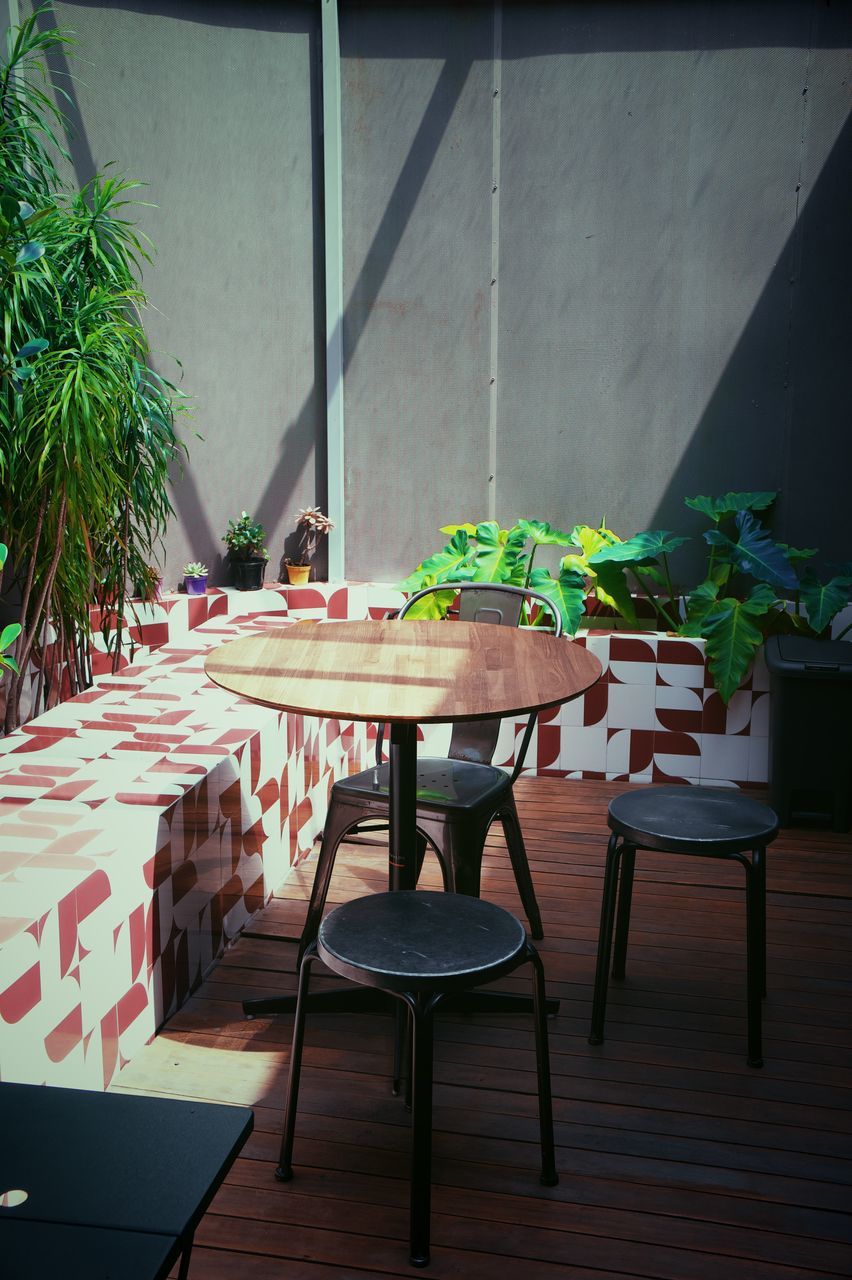 table, seat, chair, plant, furniture, no people, nature, indoors, interior design, architecture, room, wood, potted plant, food and drink, absence, business, restaurant, dining table, day, kitchen & dining room table, built structure