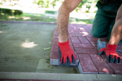 Low section of man standing on footpath