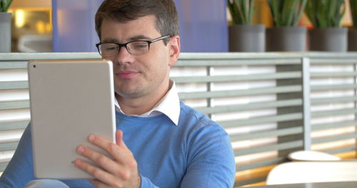 Portrait of young man using mobile phone