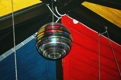 Low angle view of illuminated lighting equipment hanging on ceiling