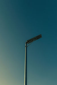 Low angle view of street light against clear blue sky