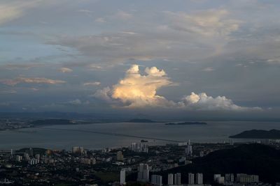 Cityscape against cloudy sky