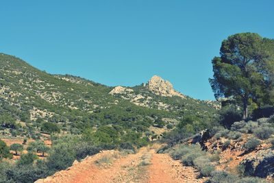 Low angle view of mountain against clear blue sky