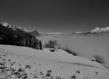 Scenic view of snow covered mountains against sky