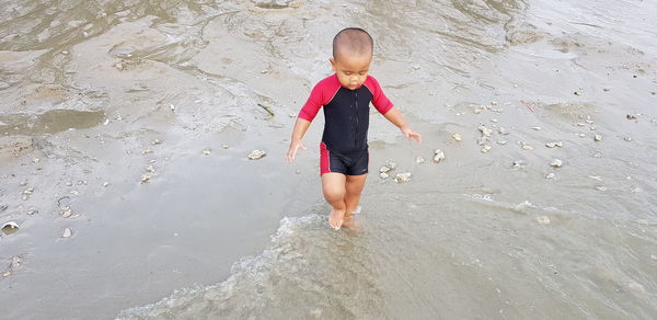 High angle view of boy playing on beach