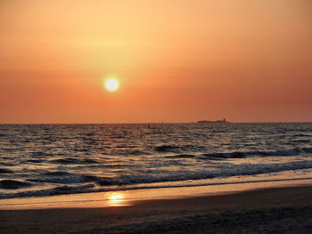 Scenic view of sea against orange sky