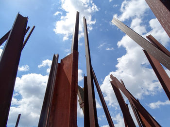 Low angle view of metal poles against sky