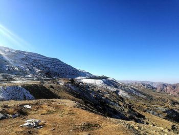 Scenic view of snowcapped mountains against clear blue sky