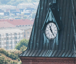 Close-up of clock on roof of building