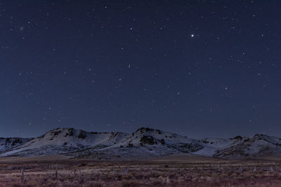 Scenic view of landscape against sky at night