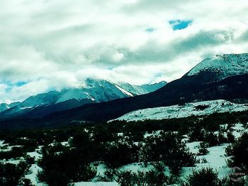 Scenic view of snowcapped mountains against sky