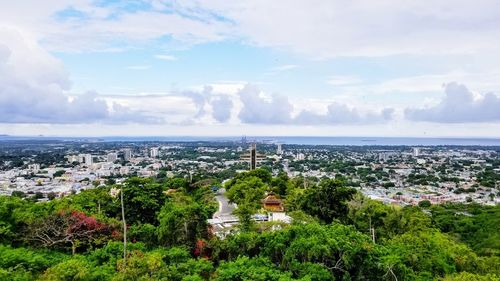 High angle view of buildings and trees against sky