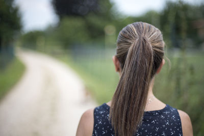 Over 50 ponytail old woman, from the back