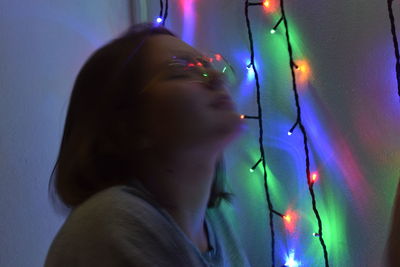 Close-up portrait of woman with illuminated lights