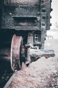 Close-up of rusty chain on railroad track