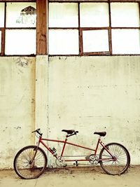 Bicycle parked against wall