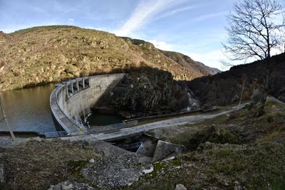 Scenic view of dam by river against sky