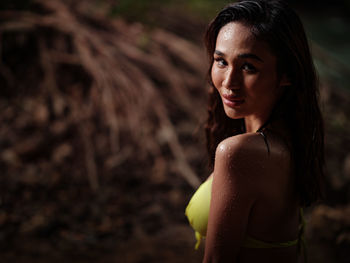 Portraiture shot of a beautiful asian female model in bikini at a river