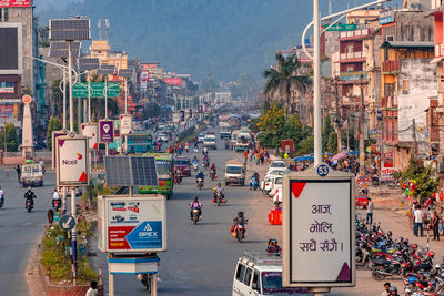 Vehicles on road against buildings in city